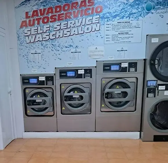Self-service washing machines under the «Lavadoras autoservicio» sign
