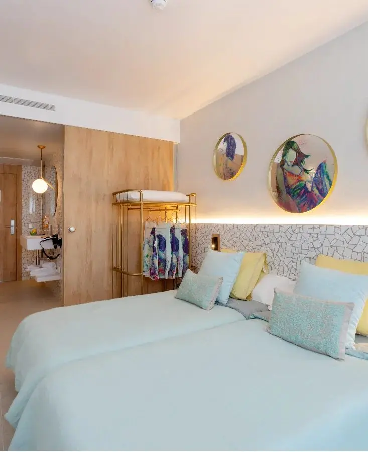 Room with two beds and colourful cushions