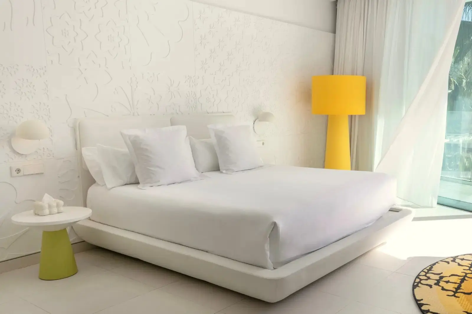 Hotel room with the bed made up in white linen