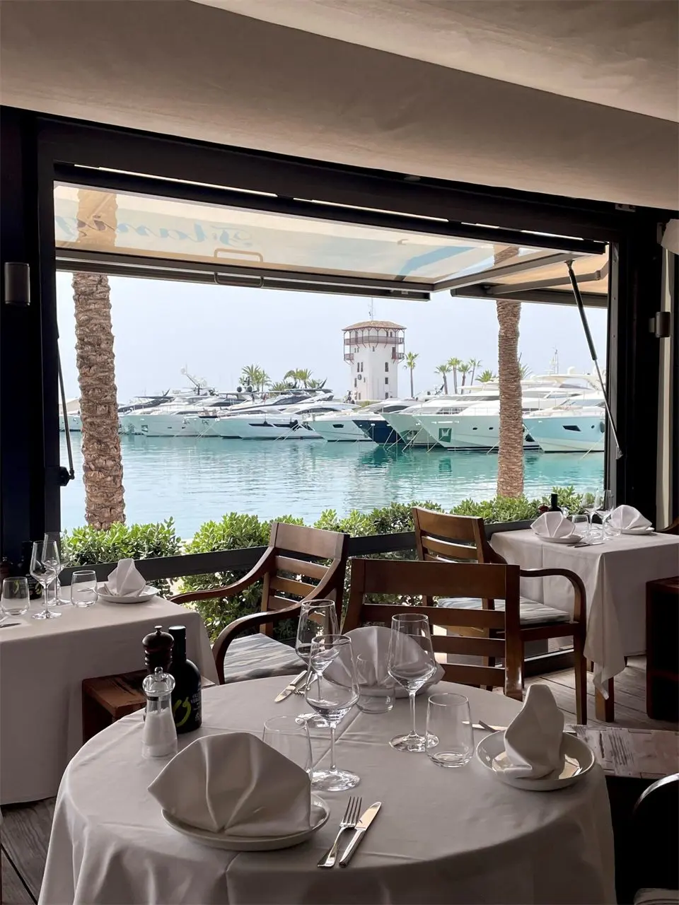 Tables with white tablecloths overlooking the marina